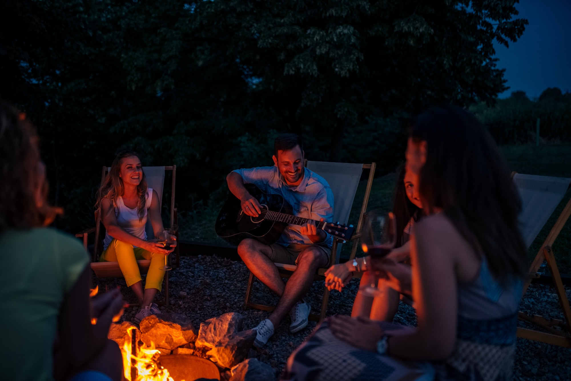 Summer vacation concept. Enjoying around the bonfire.